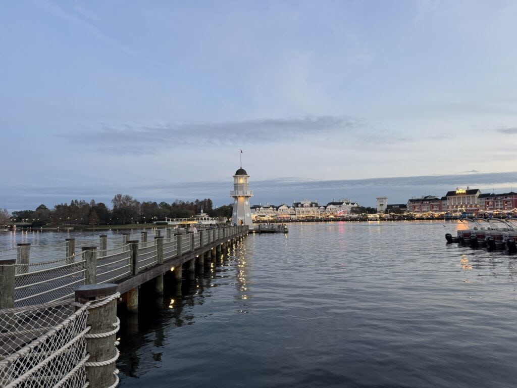 Lighthouse and boat dock at Disney’s Beach Club Resort overlooking Crescent Lake at sunset
