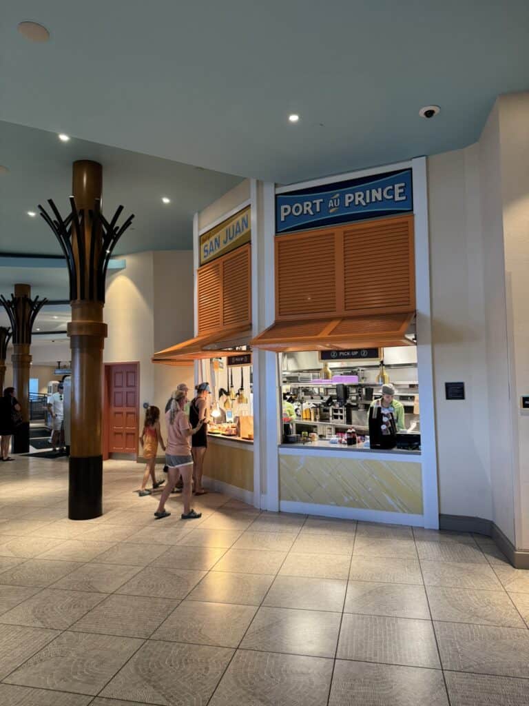 Guests picking up food at Centertown Market inside Disney's Caribbean Beach Resort.