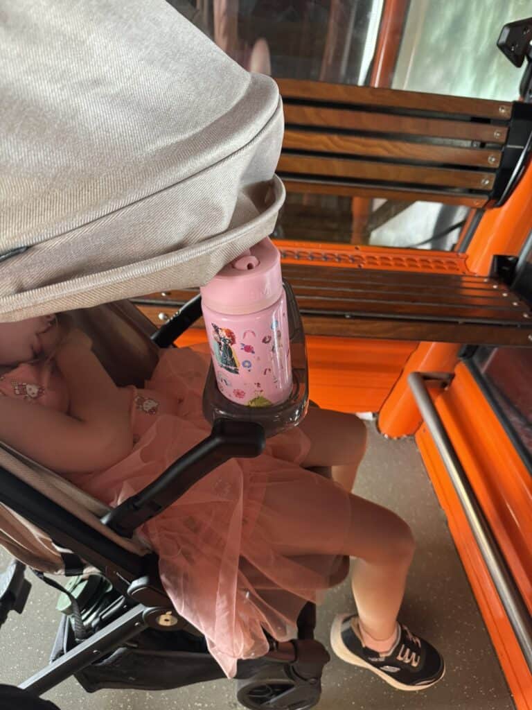 A preschooler naps comfortably in the Zoe Traveler stroller during a long day at Walt Disney World.