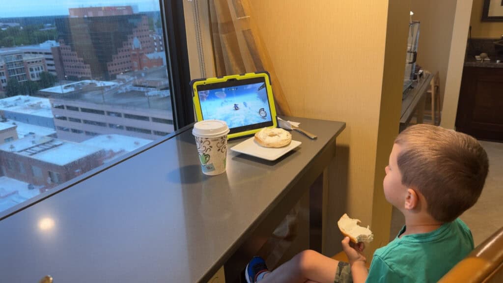 Child eating breakfast in the Marriott Columbia Club Lounge with a view of downtown Columbia, SC