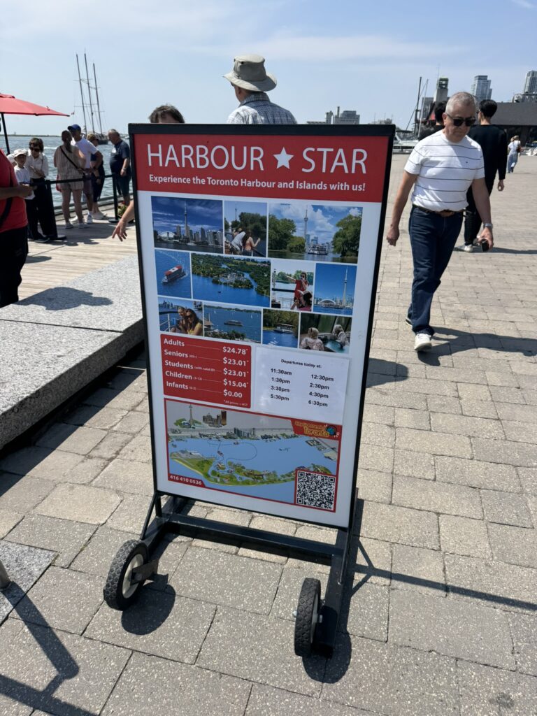 Harbour Star cruise sign showing ticket prices and departure times at Toronto Harbourfront