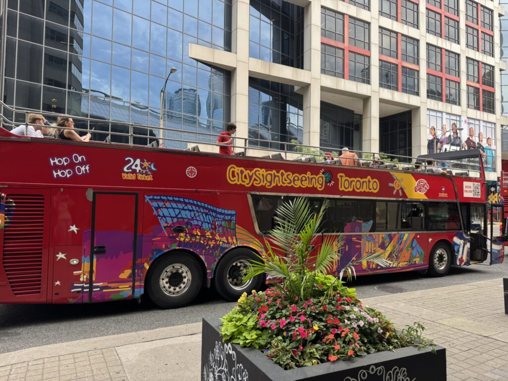 Red City Sightseeing Toronto hop-on hop-off double-decker bus in downtown Toronto