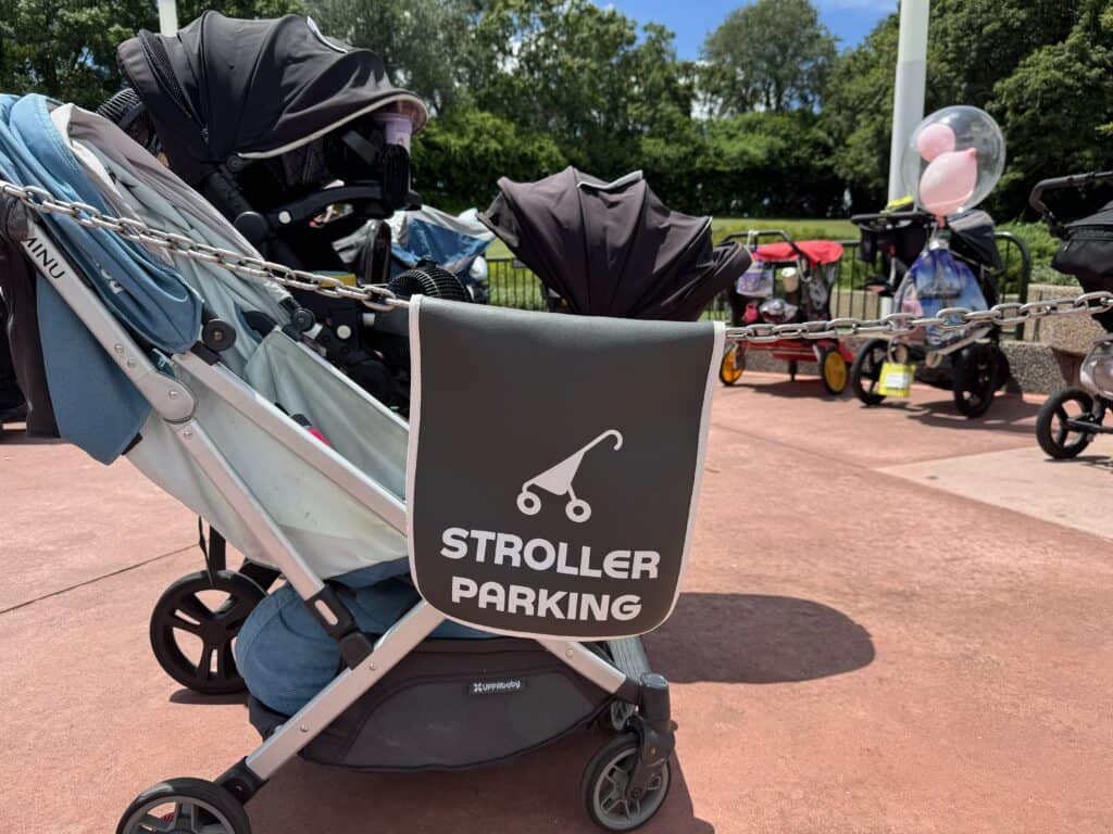Stroller parking sign attached to a stroller at Disney World with other parked strollers in the background.